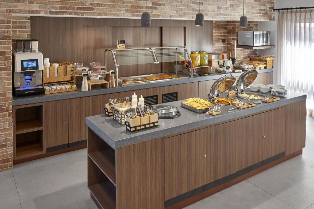 a kitchen with a counter with food on it at City Express Plus by Marriott Tijuana in Tijuana