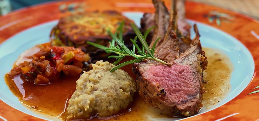 a plate of food with meat and vegetables on a table at Hotel Restaurant Le Cigalon in Waldbillig