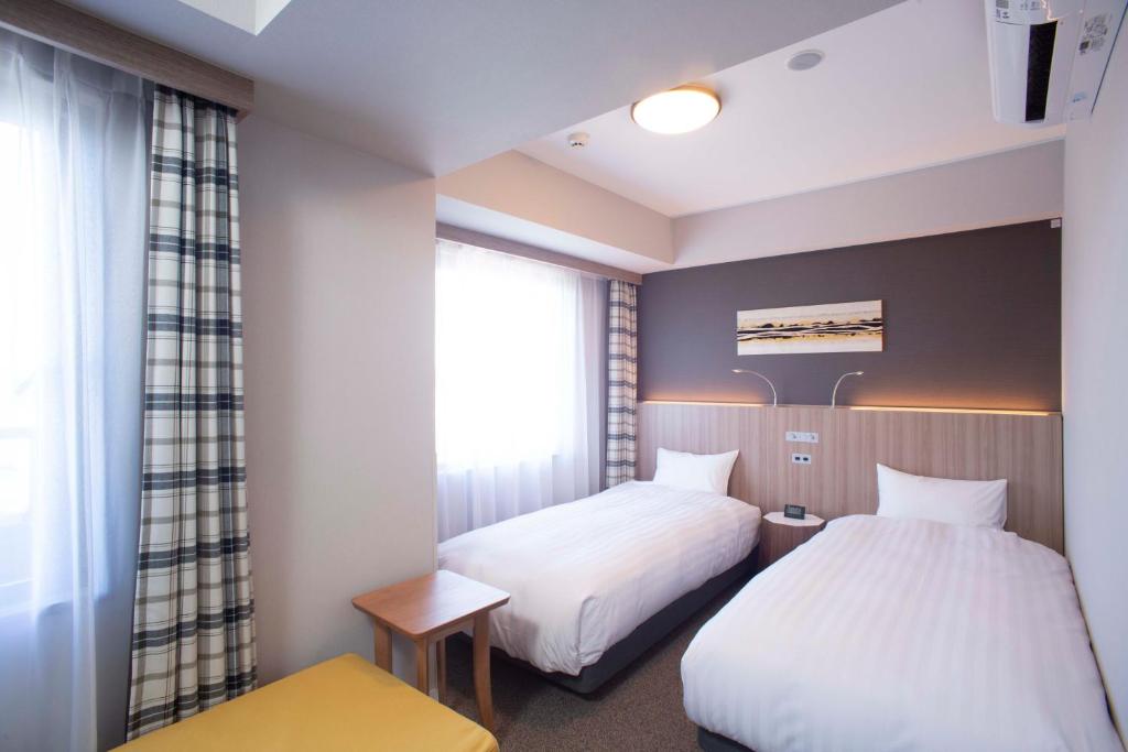 Postel nebo postele na pokoji v ubytování Shinrin Hotel