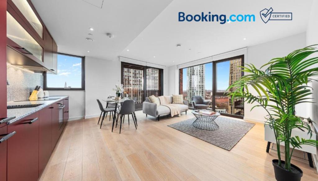 a kitchen and living room with a couch and a table at Central London New 2 bedroom flat Riverview Balcony in London