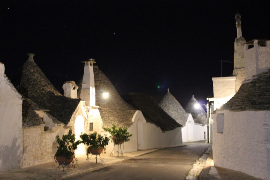 a group of white buildings at night at Il Gabellota Resort in Alberobello