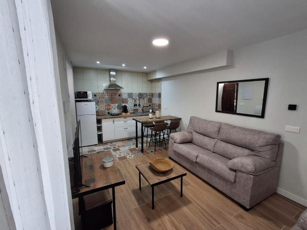 a living room with a couch and a table at Apartamentos Tierra Lavanda in Brihuega