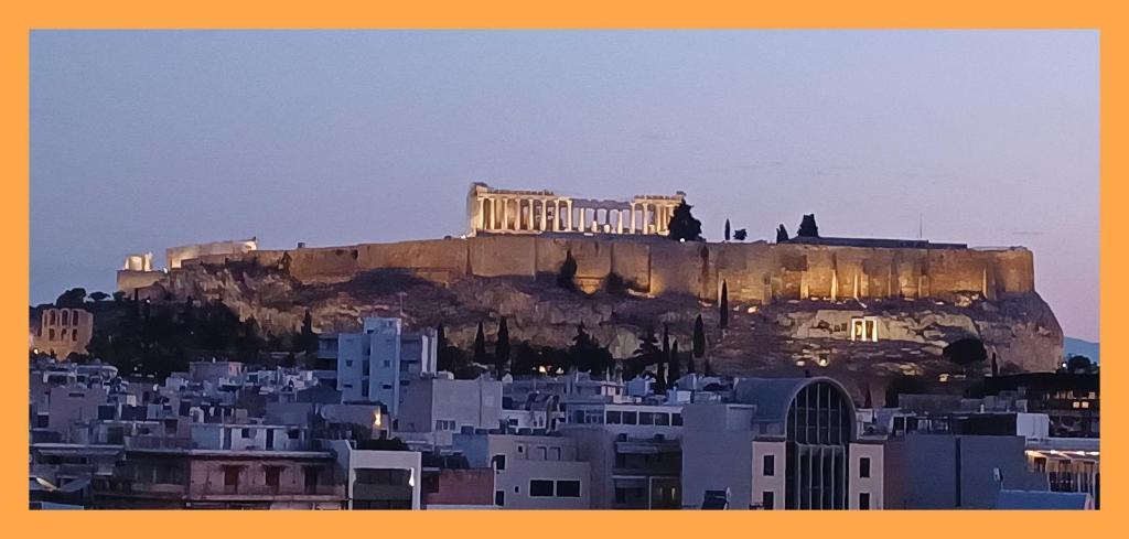 a building on top of a mountain with buildings at cozy διαμέρισμα με υπέροχη θέα ! in Athens