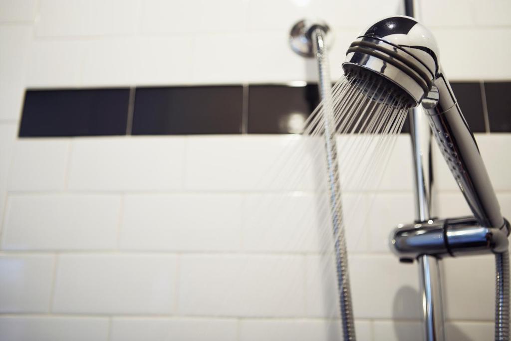 a shower head with water coming out of it at Hôtel Le Germain Québec in Quebec City