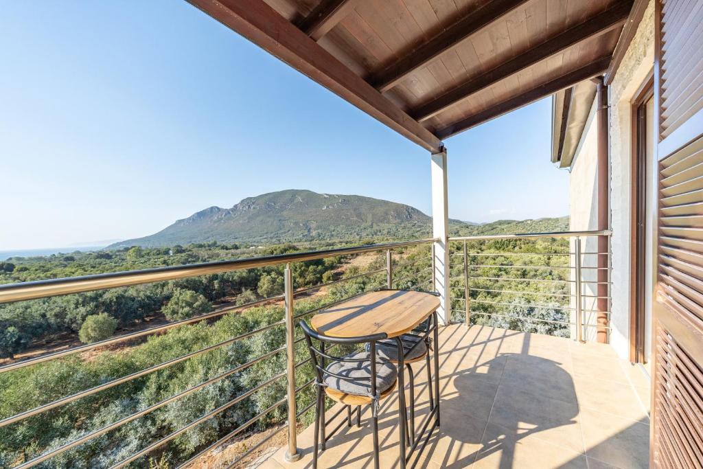 a table and chairs on a balcony with a view at Melissa apartments 1 in Halikounas