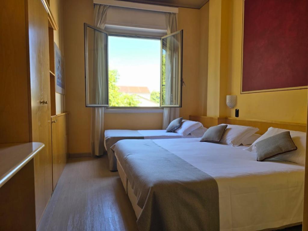 Posteľ alebo postele v izbe v ubytovaní Mokinba Hotels Sant'Ambroeus