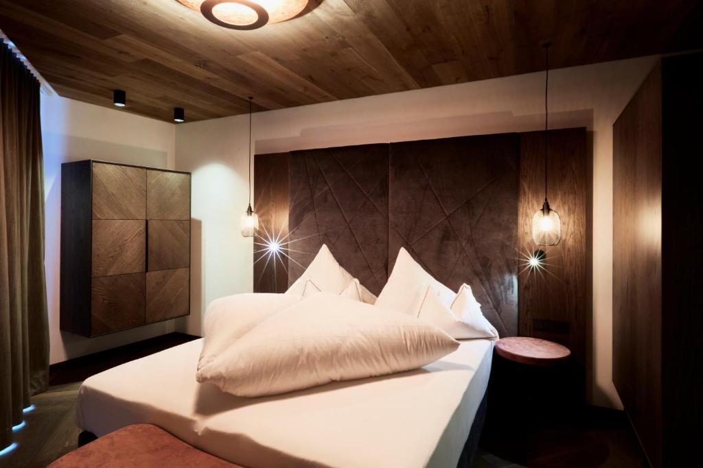 Postel nebo postele na pokoji v ubytování Hotel Alpina
