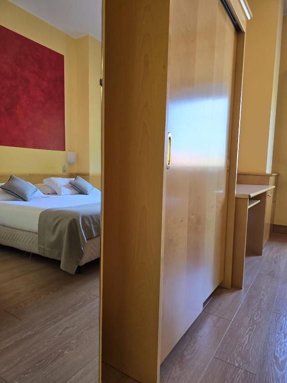 Posteľ alebo postele v izbe v ubytovaní Mokinba Hotels Sant'Ambroeus