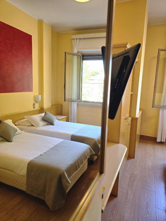 Posteľ alebo postele v izbe v ubytovaní Mokinba Hotels Sant'Ambroeus