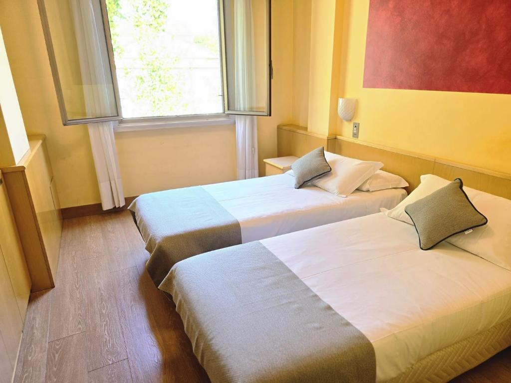 Posteľ alebo postele v izbe v ubytovaní Mokinba Hotels Sant'Ambroeus