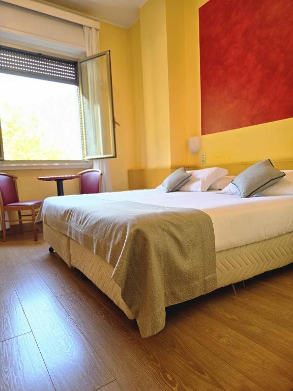 Posteľ alebo postele v izbe v ubytovaní Mokinba Hotels Sant'Ambroeus