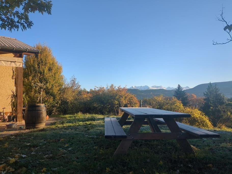 a picnic table in the grass next to a house at Villa familiale gap nature jardin in Gap