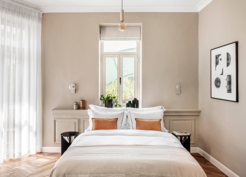 Postel nebo postele na pokoji v ubytování Noel Suites