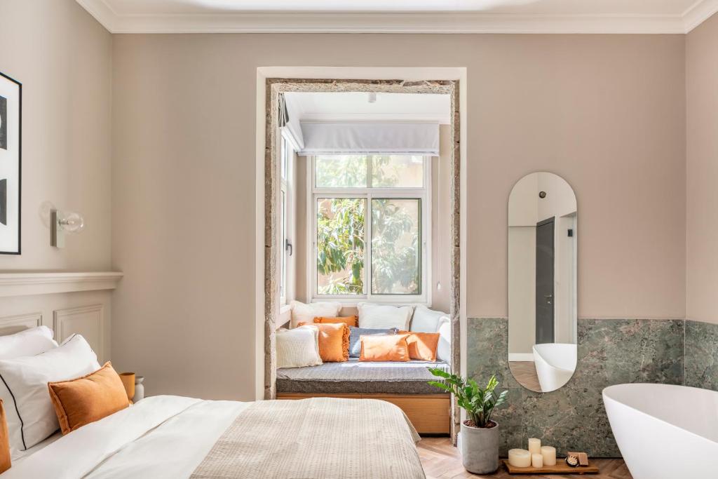 Postel nebo postele na pokoji v ubytování Noel Suites