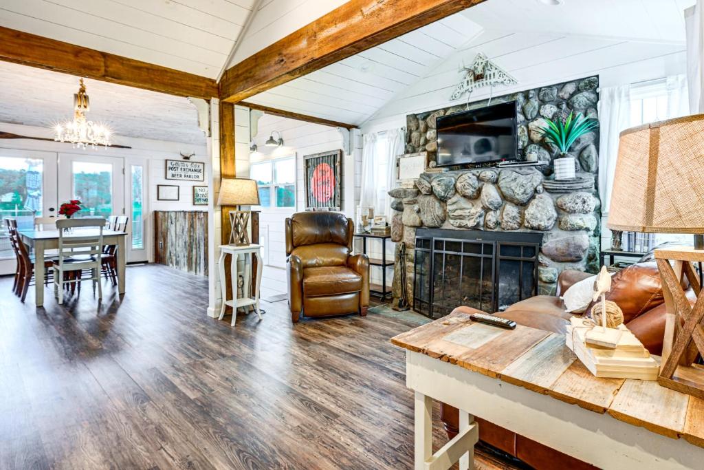 Family-Friendly Retreat on Gilletts Lake! في جاكسون: غرفة معيشة مع موقد وطاولة