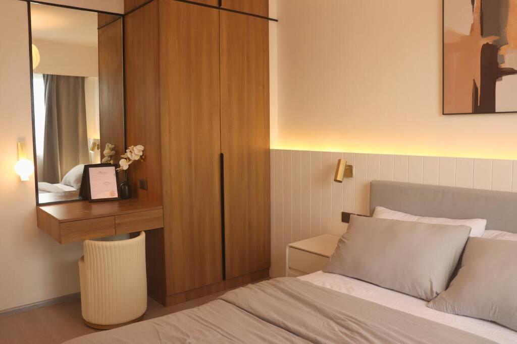 a bedroom with a bed and a desk and a mirror at Modern Nordic 1 Bedroom Condo near Eastwood, Quezon City in Manila