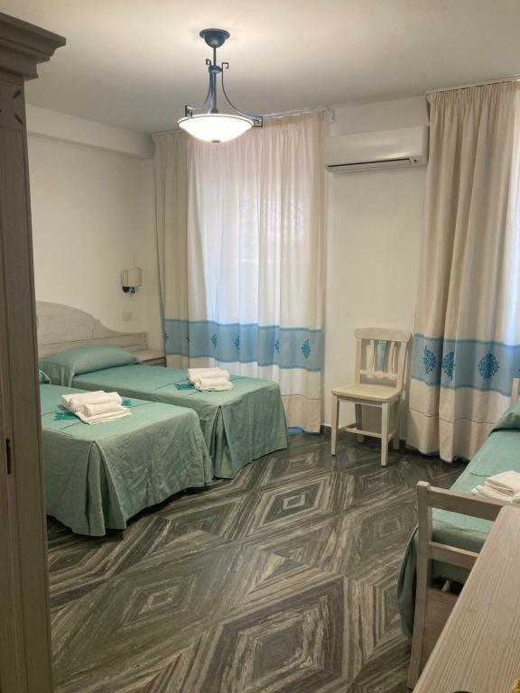 Postel nebo postele na pokoji v ubytování Hotel Villa Campana