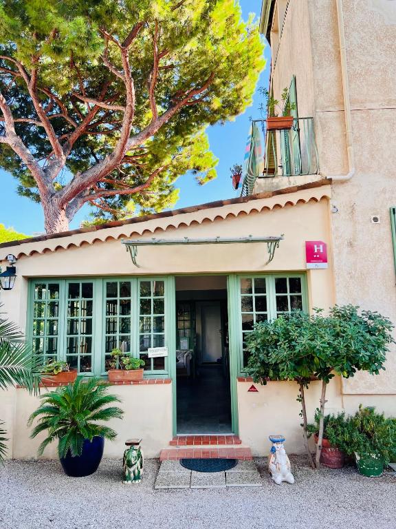 a house with plants in front of it at Hotel Le Ponteil in Antibes
