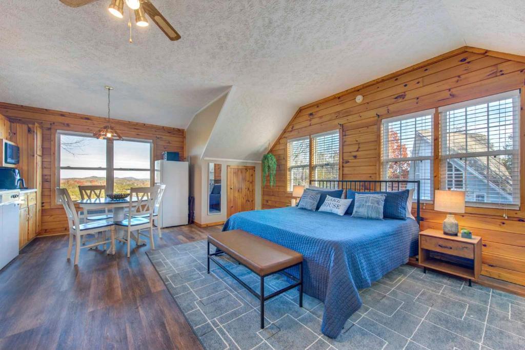 Un dormitorio con una cama y una mesa y una cocina. en Near Douglas Lake Mountain Jewel Haven with Views, en Sevierville