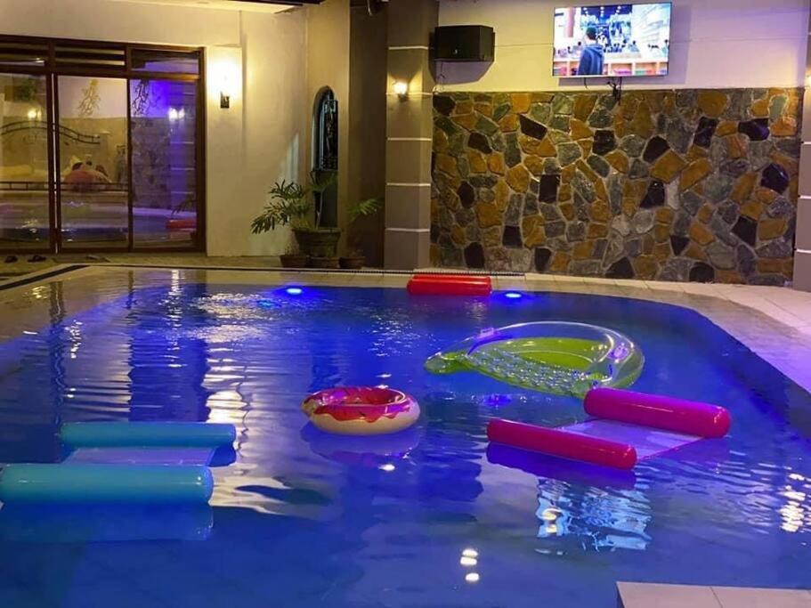 a pool with a water slide in a hotel at Elle Casa is a modern-European inspired house coc in San Pablo