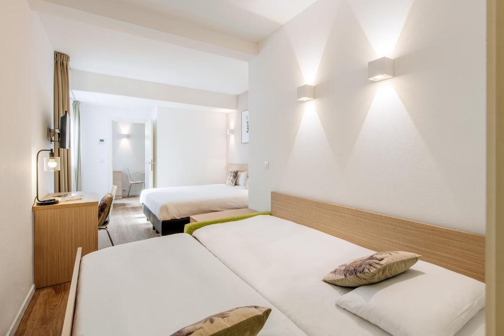 Postel nebo postele na pokoji v ubytování Aparthotel Adagio Access Bruxelles Europe Aparthotel