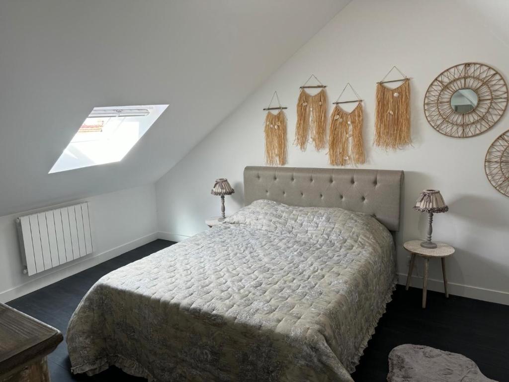 une chambre avec un lit et deux lampes au mur dans l'établissement Bohème chic, à Faremoutiers