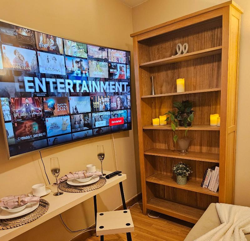 a living room with a tv and a table at Cosy London Apartment with Great Views in London