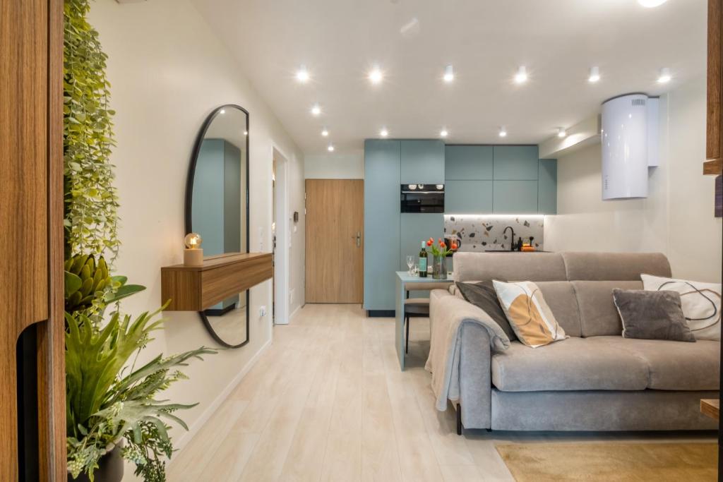 a living room with a couch and a kitchen at MyFlat Wave Luxury 44 Suite in Siófok
