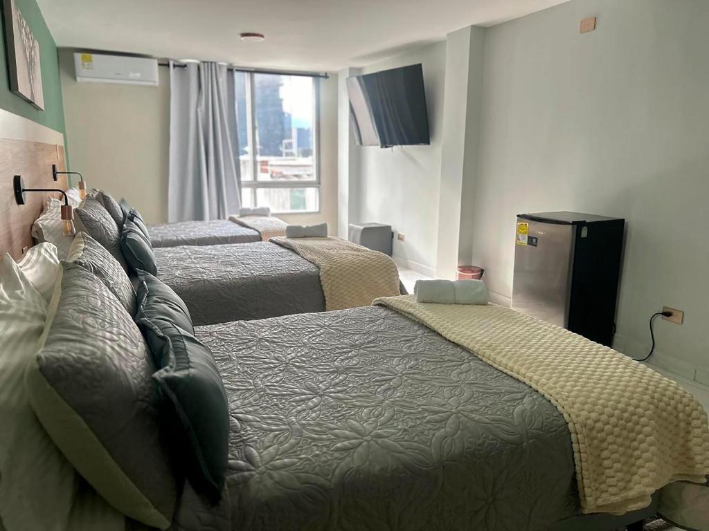 Postel nebo postele na pokoji v ubytování Provenza Medellin Hotel Boutique