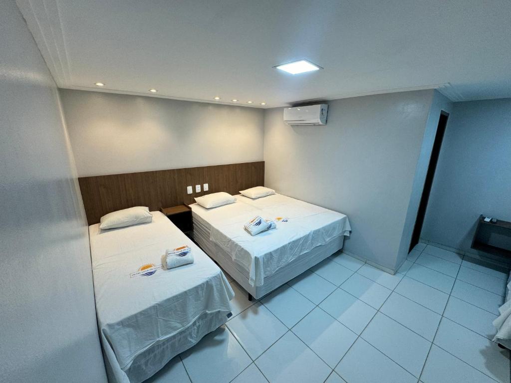 Postel nebo postele na pokoji v ubytování Hotel Luar de Itapua