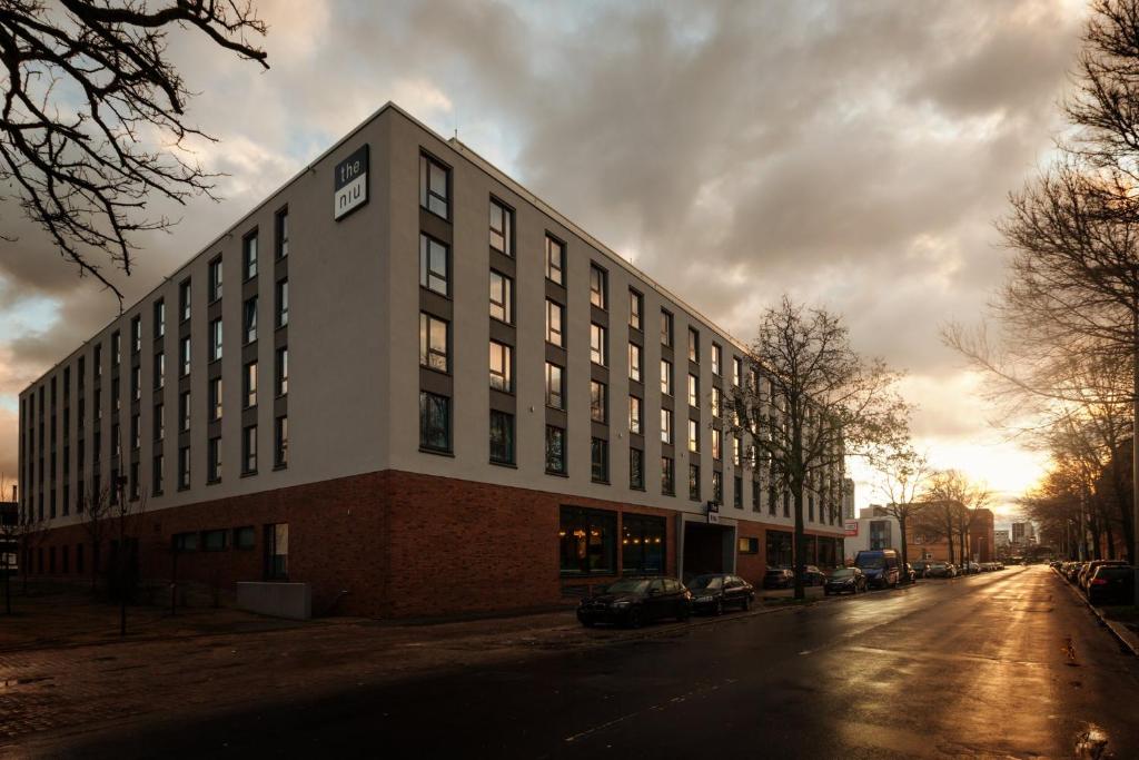 a large building on the side of a street at Holiday Inn - the niu, Mood Mainz by IHG in Mainz