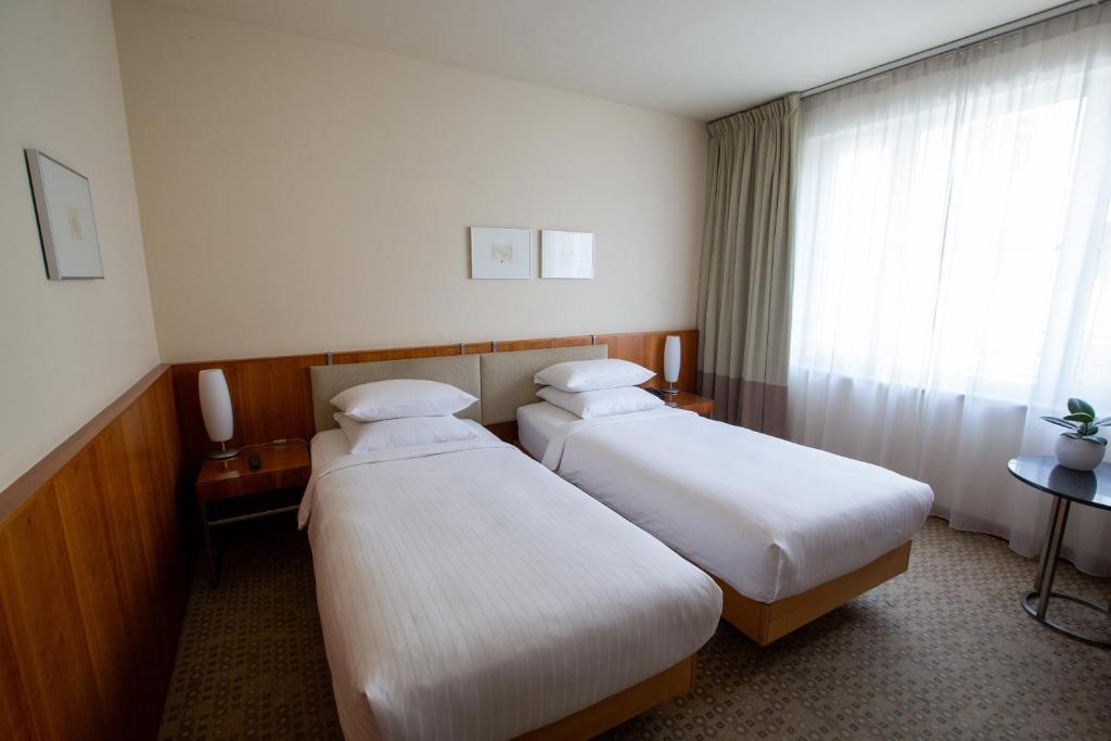 Postel nebo postele na pokoji v ubytování K+K Hotel Central