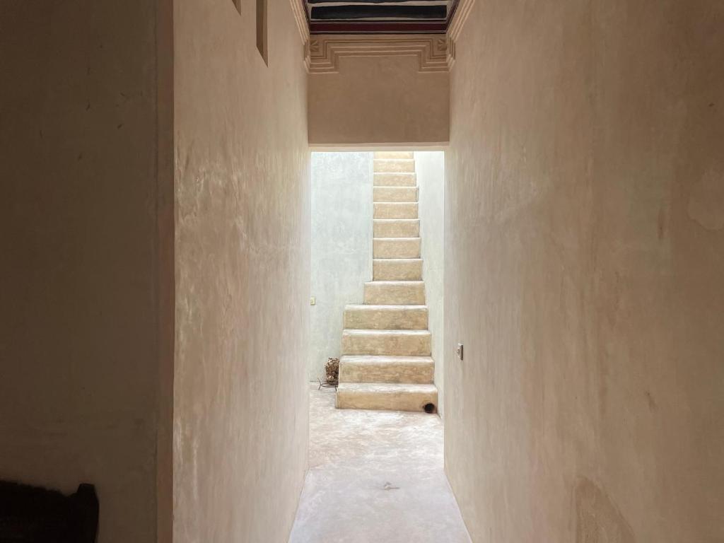 a hallway of a house with stairs in the background at Umma House in Lamu