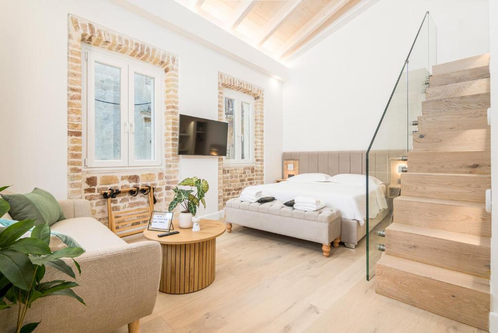 a bedroom with a bed and a living room at Murofinto Homes De Vecchio in Corfu