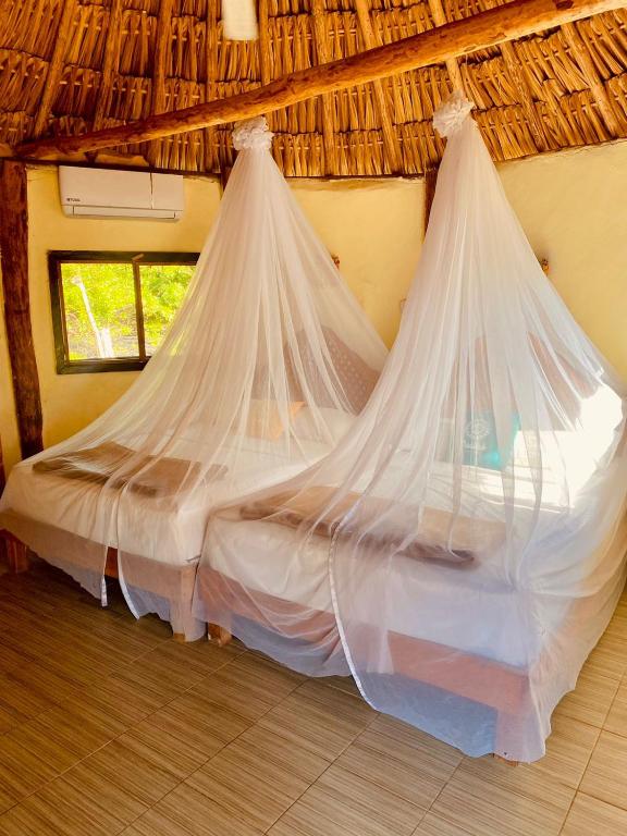 Postel nebo postele na pokoji v ubytování Cabanas Jaalkab