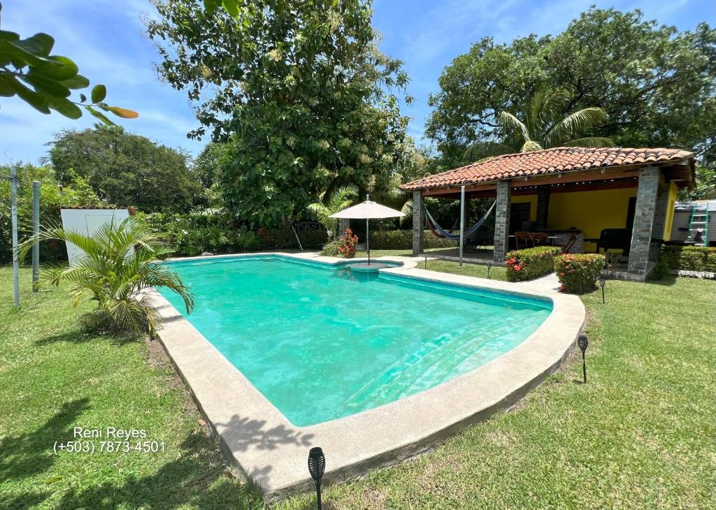 a swimming pool in a yard with a gazebo at Las Veraneras Villa - Pet Friendly in Acajutla