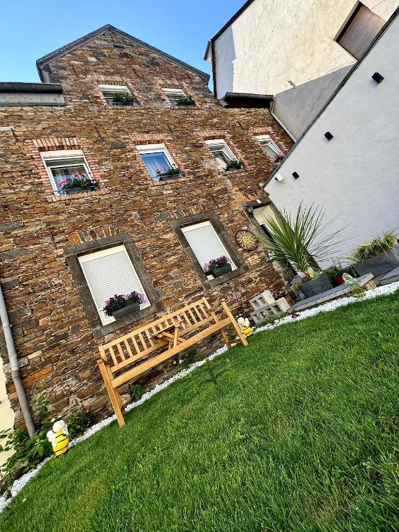 a brick building with a bench in front of it at Ada&Cris Apartament in Klotten