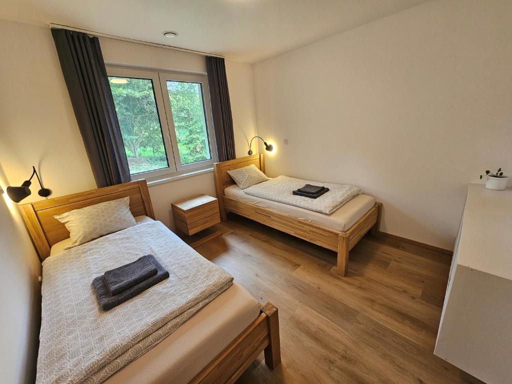 Postel nebo postele na pokoji v ubytování Apartmán v tichu