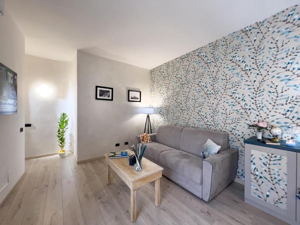 a living room with a couch and a wall at Lezioso, Apartments in Florence in Florence