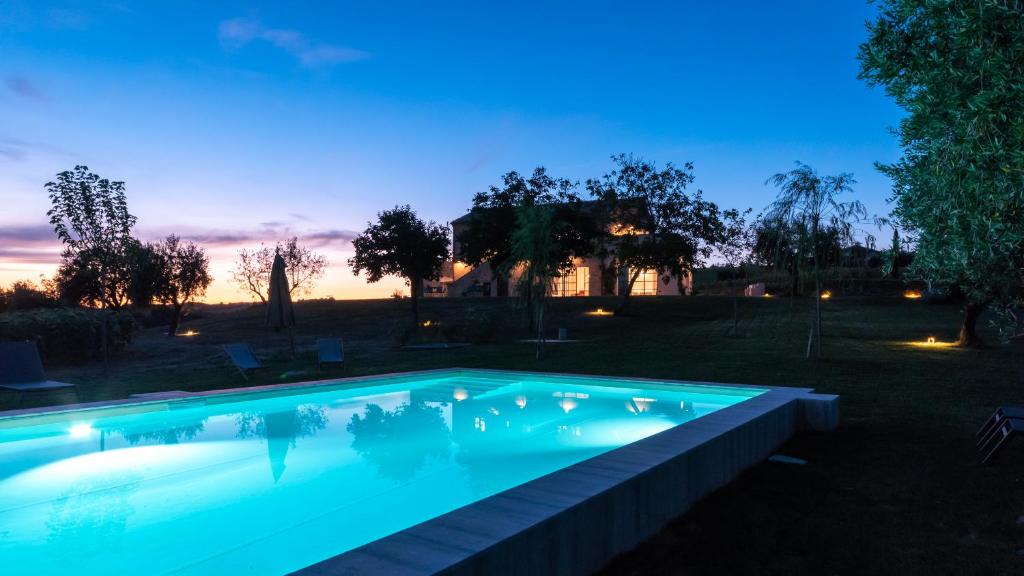 Una piscina en un patio trasero por la noche. en La Buona Maniera, en Monteprandone