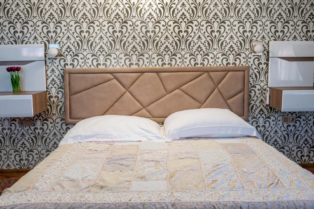 Postel nebo postele na pokoji v ubytování Enika Hotel