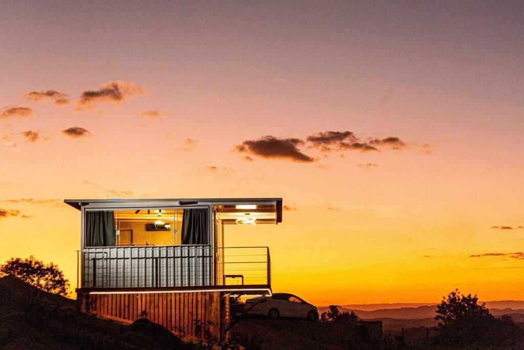 a tiny house on top of a hill at sunset at Cabana panorâmica in Cunha