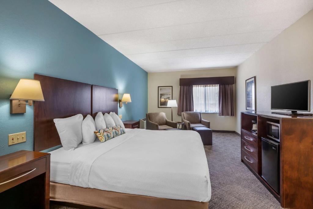 a hotel room with a bed and a flat screen tv at Best Western Port Clinton in Port Clinton