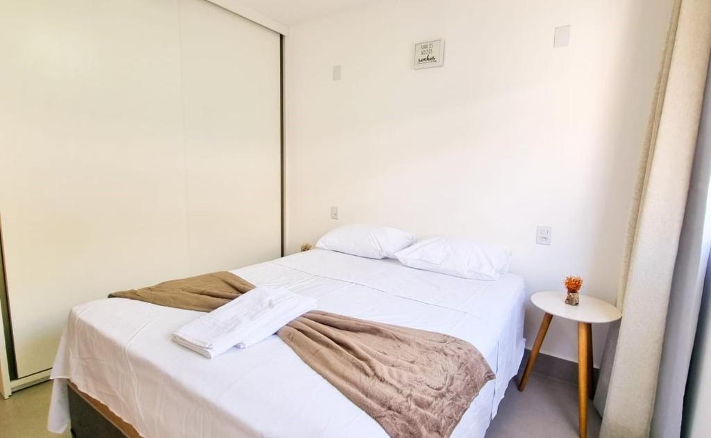 a small bedroom with a bed with a mirror at Espaço Motta - Diamantina - MG in Diamantina
