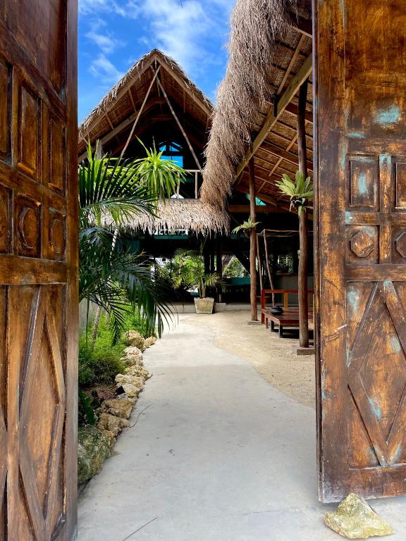 an entrance to a resort with a thatch roof at La Bohème Boutique Glamping in General Luna