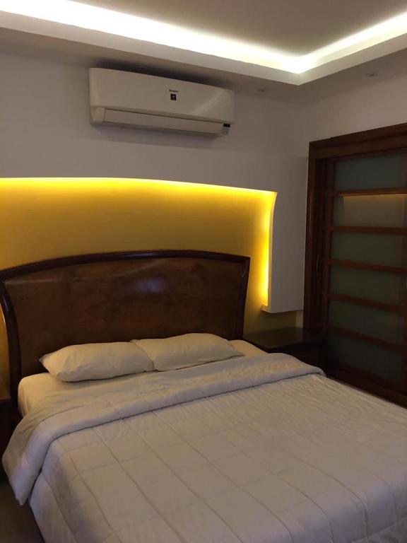 a bedroom with a large bed with a white blanket at Tallinn Travel in Sharm El Sheikh