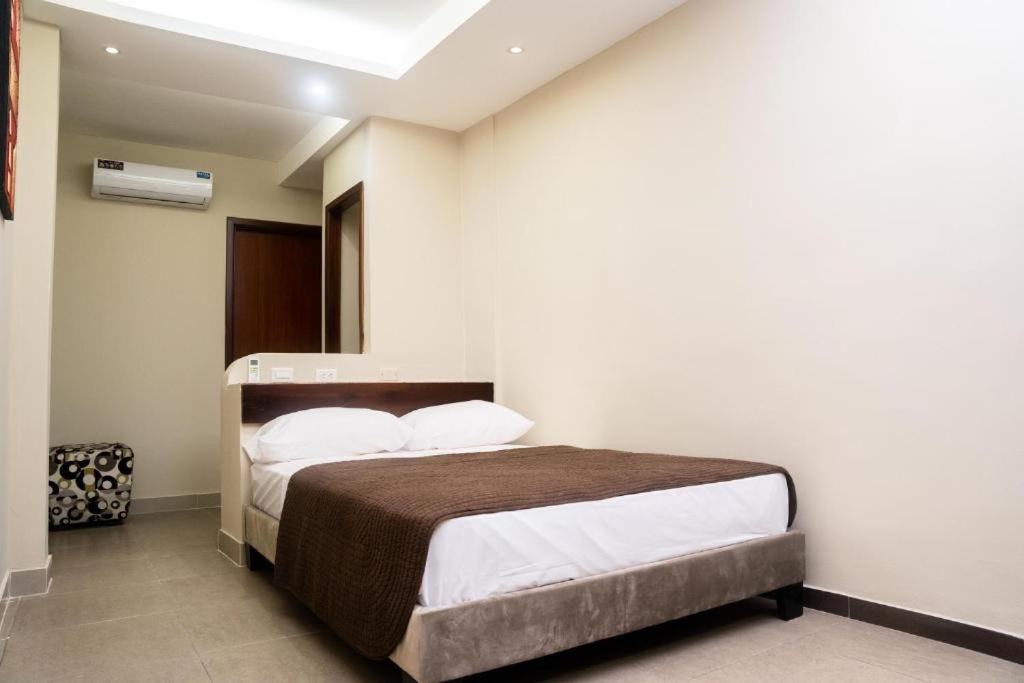 Postel nebo postele na pokoji v ubytování HM International Hotel