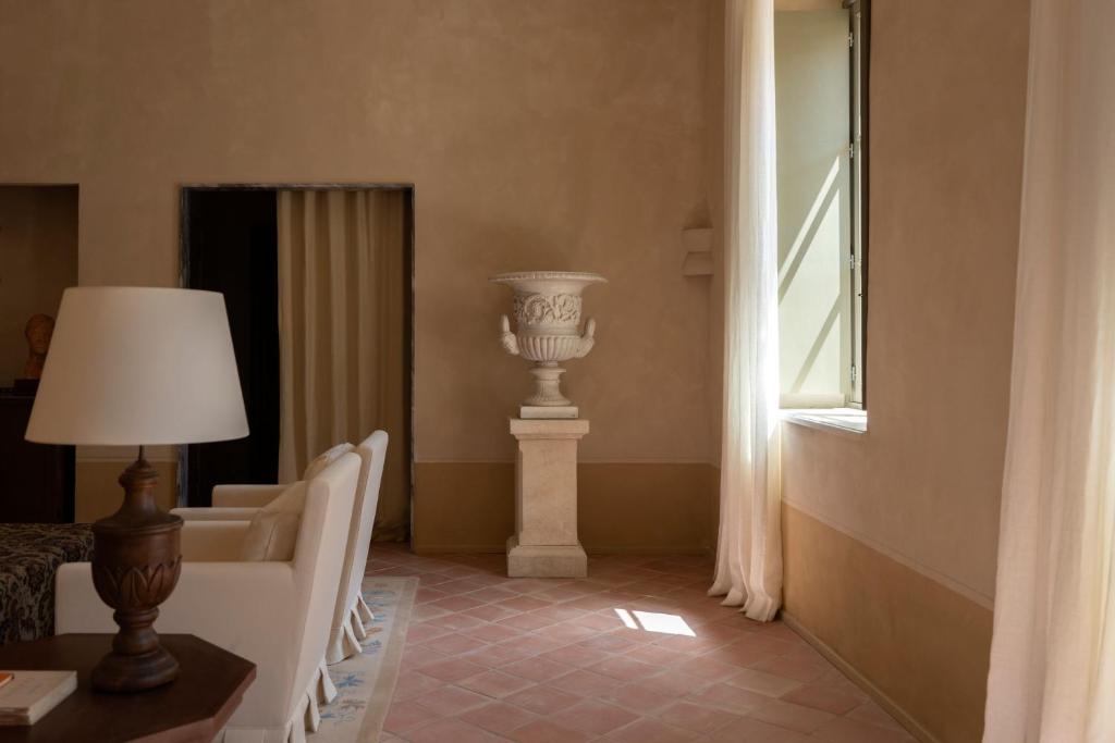a room with a column and a lamp and a window at Hôtel du Couvent, a Luxury Collection Hotel, Nice in Nice