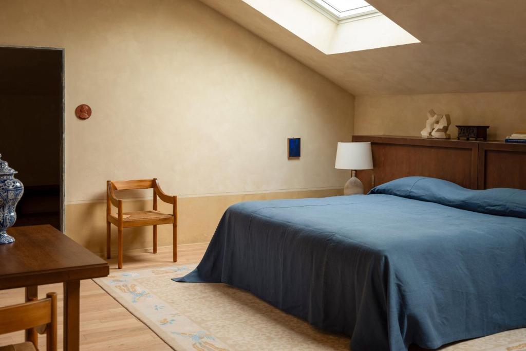 a bedroom with a bed and a table and a chair at Hôtel du Couvent, a Luxury Collection Hotel, Nice in Nice