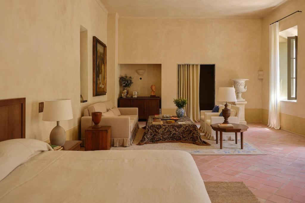 a bedroom with a bed and a living room at Hôtel du Couvent, a Luxury Collection Hotel, Nice in Nice